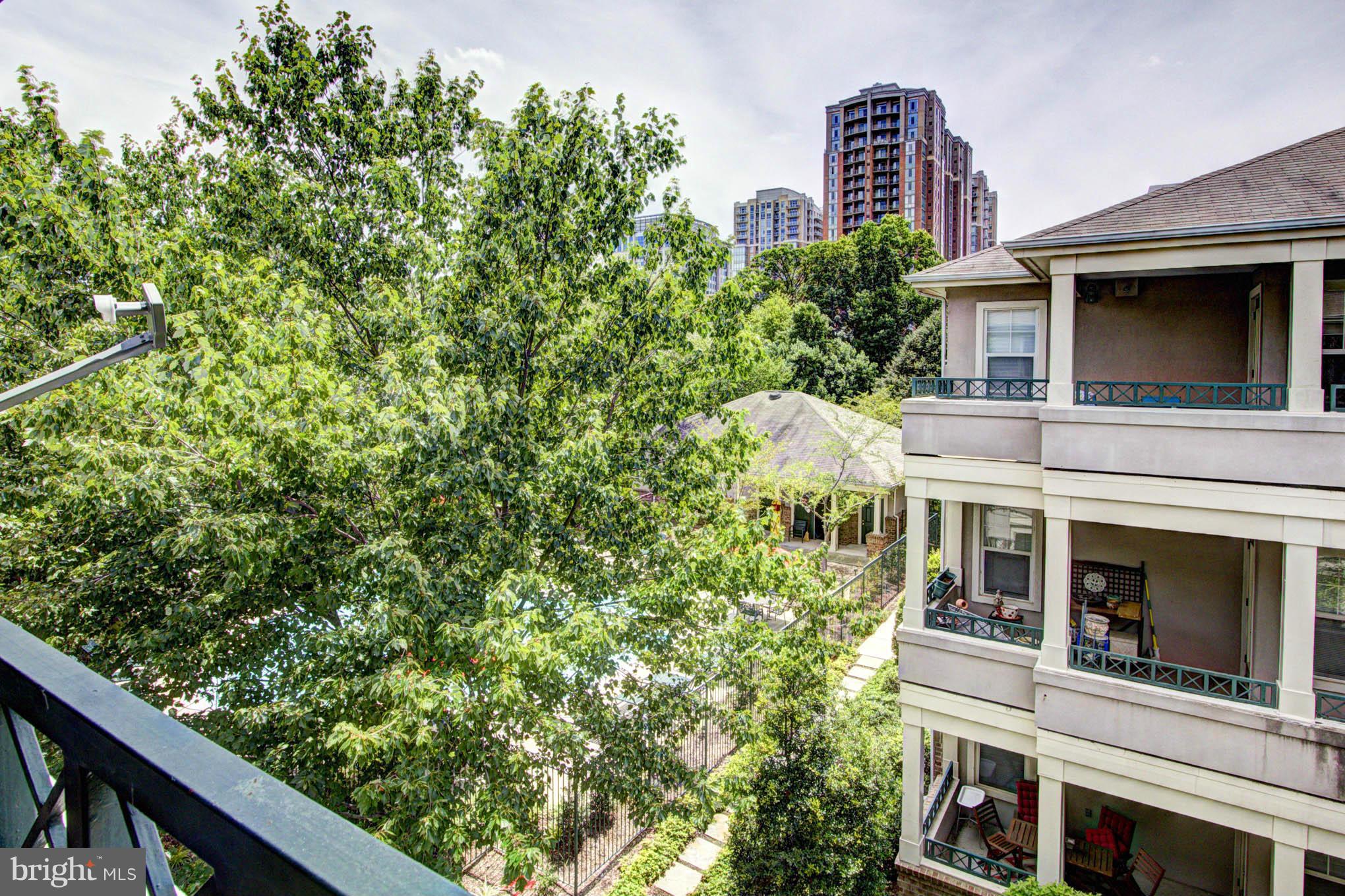 12016 Taliesin Place, Unit 34 Reston, VA 20190 - Photo 24 of 30 a view of a house with a tree