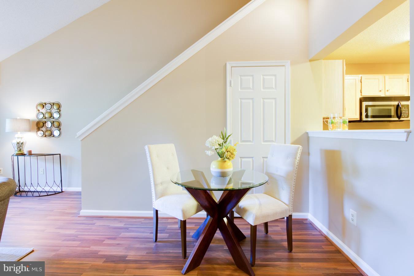 12016 Taliesin Place, Unit 34 Reston, VA 20190 - Photo 9 of 30 a view of a dining room with furniture and wooden floor