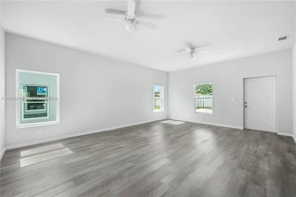 a view of kitchen with wooden floor electronic appliances and window