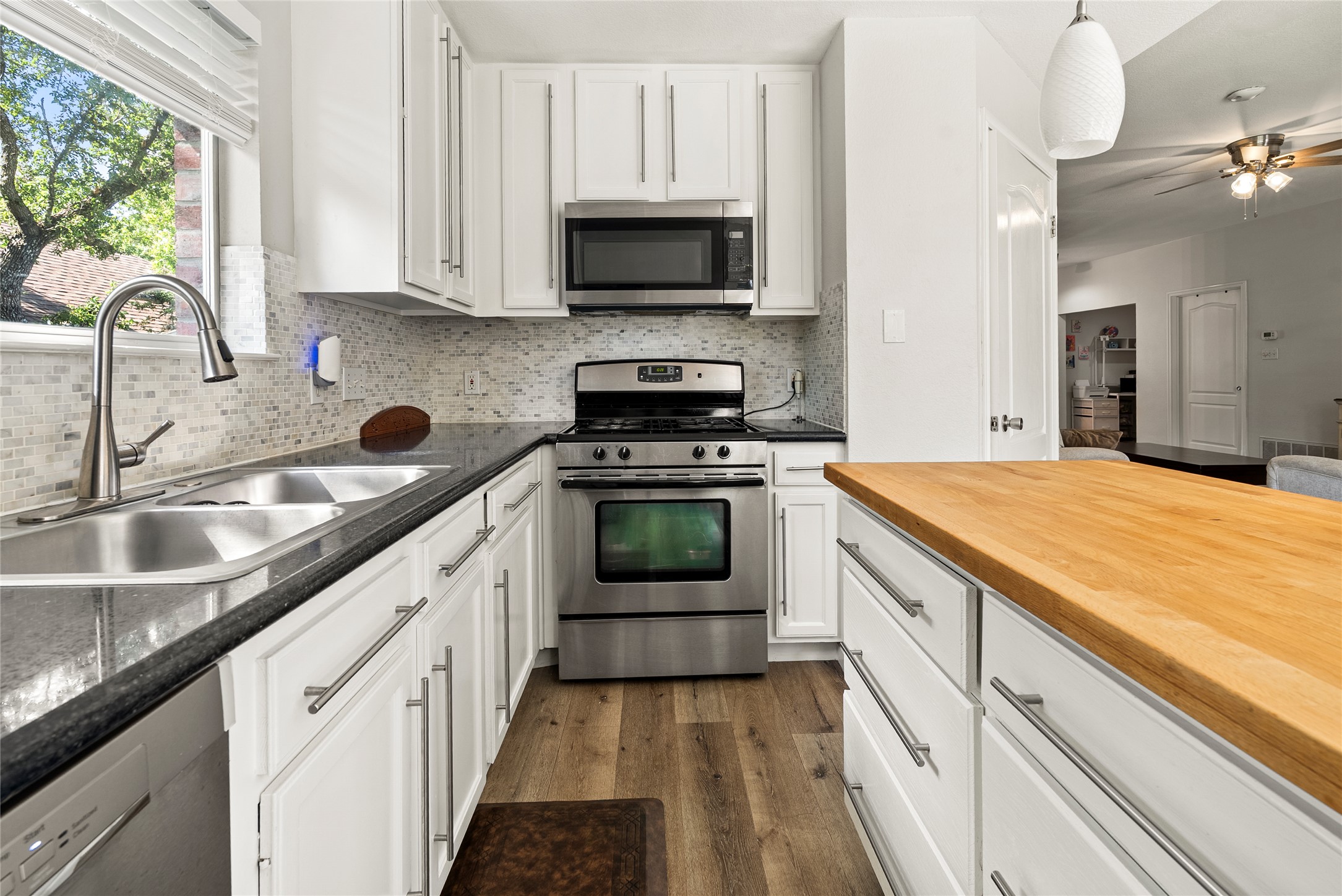 9024 Heiden Lane Austin, TX 78749 - Photo 17 of 33 Stainless steel appliances fit perfectly into the cabinetry layout, offering a highly functional cooking space with everything close at hand