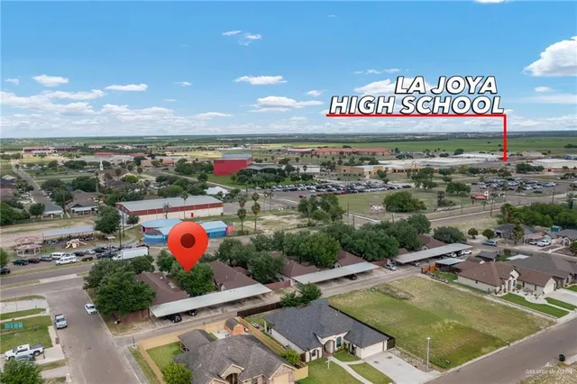 a view of a pool with a table and chairs
