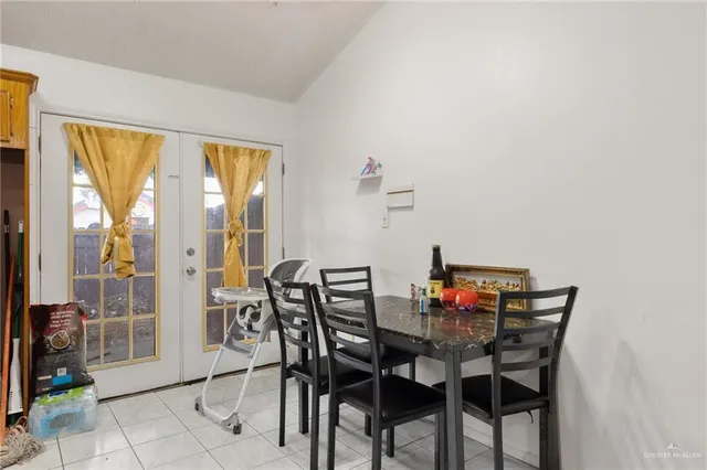 a view of a dining room with furniture and a window