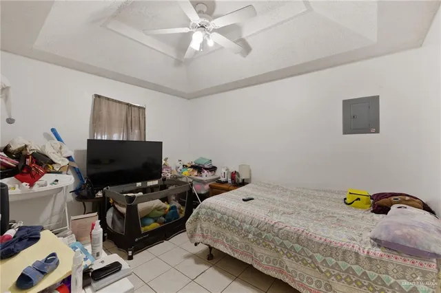 a bedroom with bed and a flat screen tv