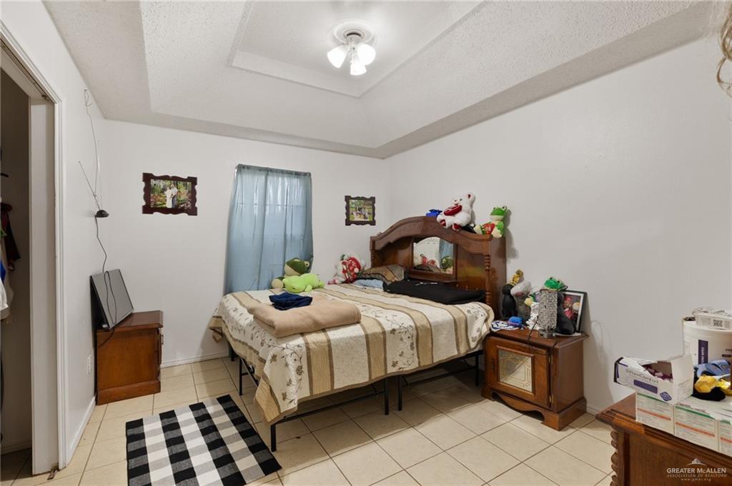 300 North Coyote Boulevard La Joya, TX 78560 - Photo 10 of 24 a bedroom with a bed and wooden floor