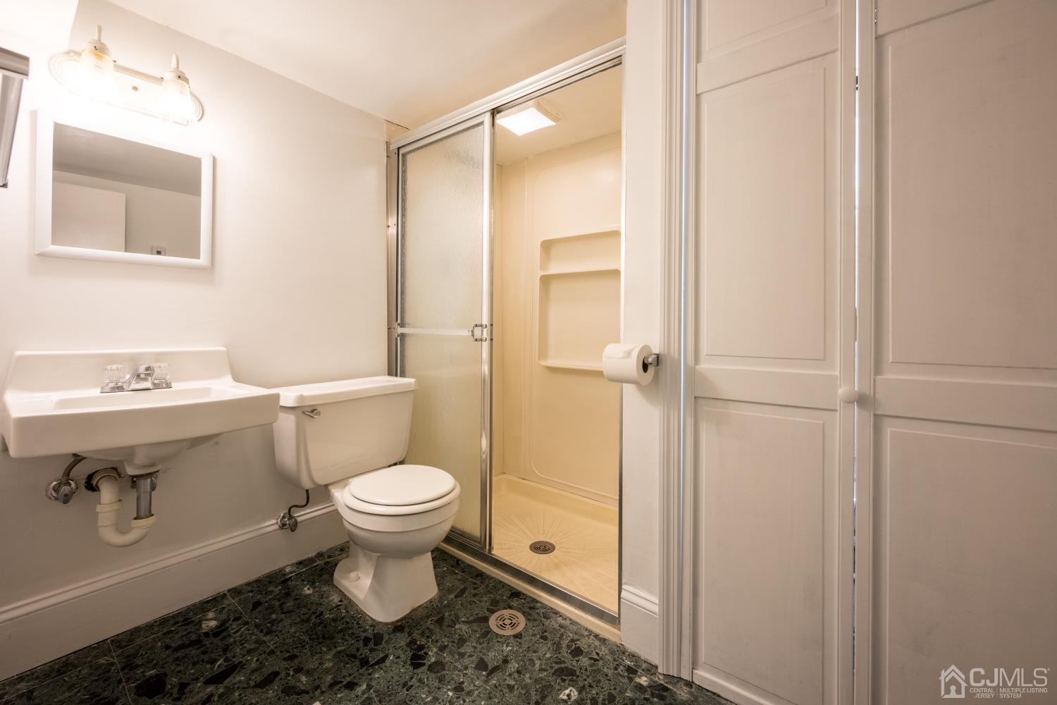 120 Rector Street Perth Amboy, NJ 08861 - Photo 13 of 34 a bathroom with a toilet sink and a mirror