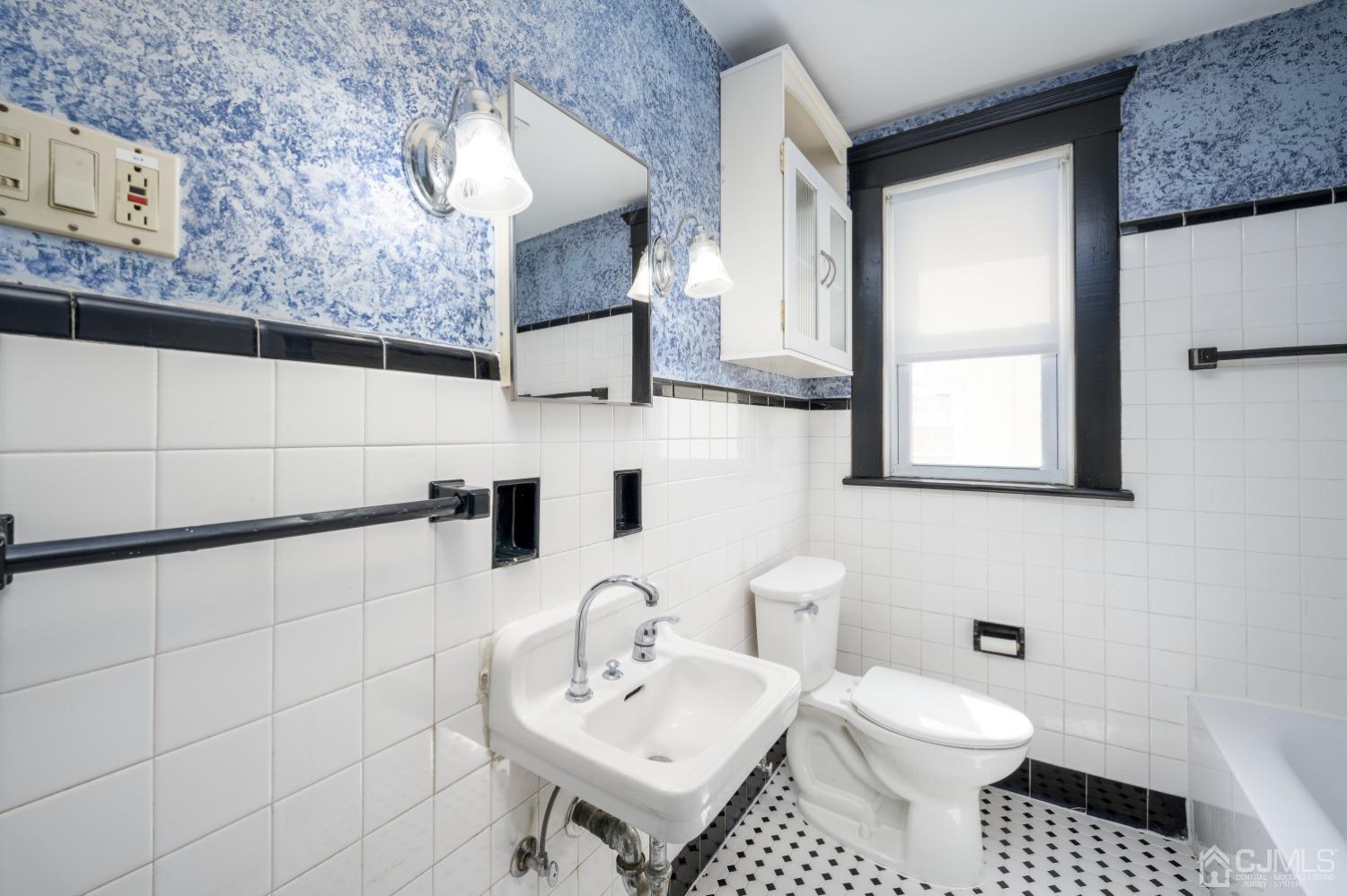 120 Rector Street Perth Amboy, NJ 08861 - Photo 21 of 34 a bathroom with a toilet sink and mirror