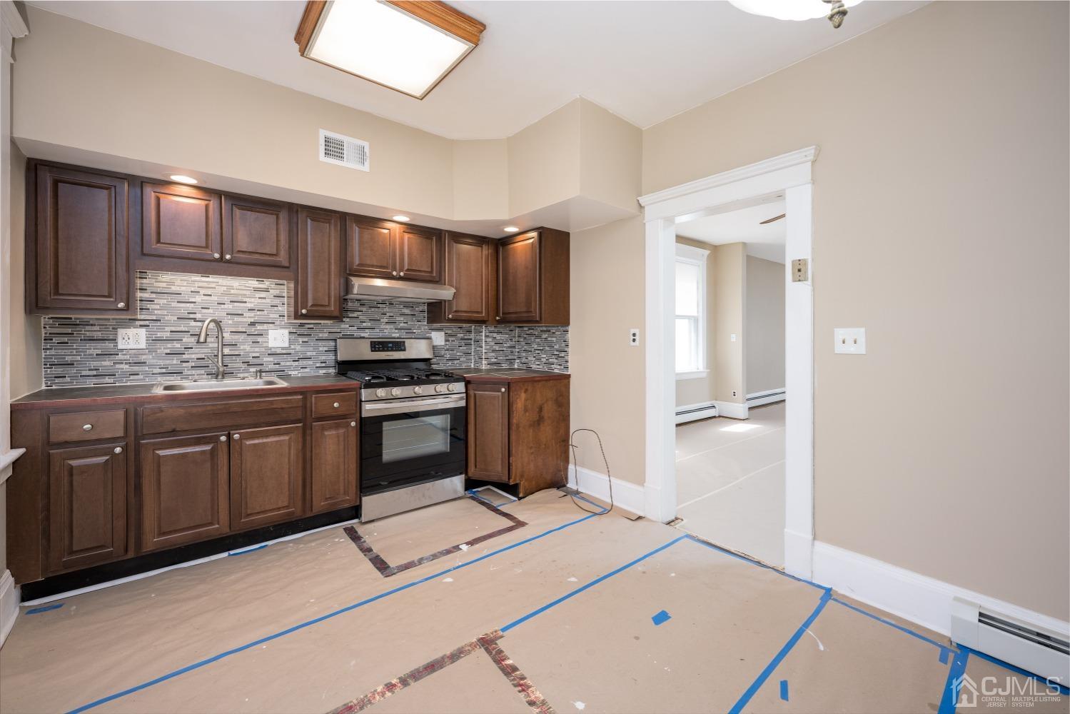 120 Rector Street Perth Amboy, NJ 08861 - Photo 23 of 34 a kitchen with a sink cabinets and stainless steel appliances