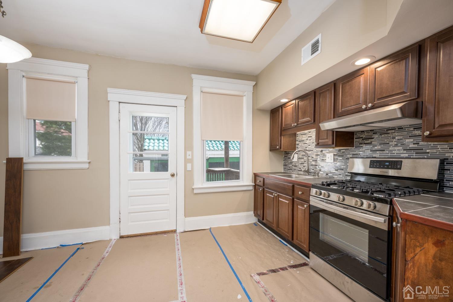 120 Rector Street Perth Amboy, NJ 08861 - Photo 26 of 34 a kitchen with stainless steel appliances granite countertop a stove and a sink