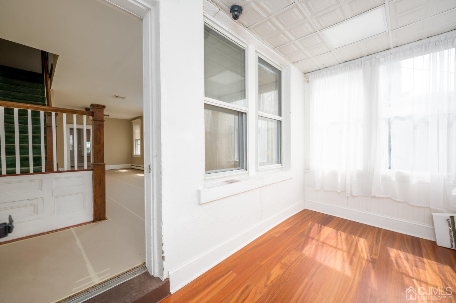 120 Rector Street Perth Amboy, NJ 08861 - Photo 30 of 34 a view of an empty room with wooden floor and a window