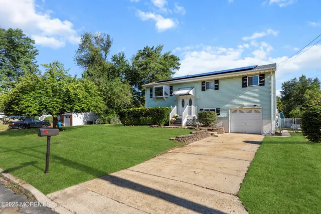 a front view of house with a garden and patio
