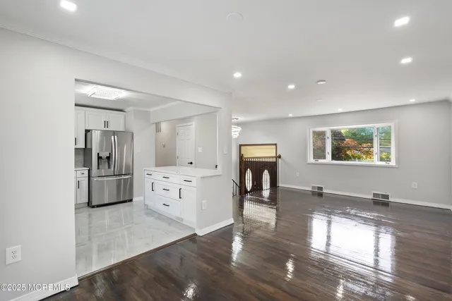 a kitchen with a refrigerator and a stove top oven