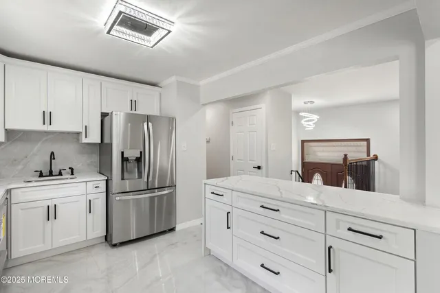 a kitchen with cabinets stainless steel appliances and a counter space