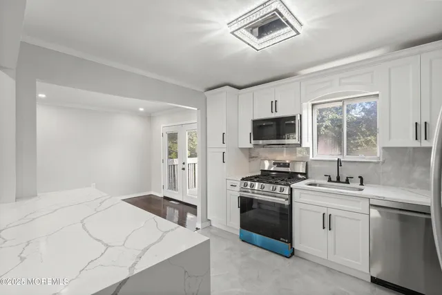 a kitchen with a stove a sink and a microwave