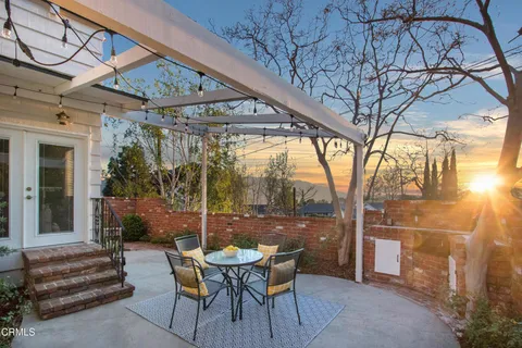 a view of a porch with furniture and a yard