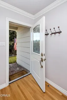 a view of a livingroom with wooden floor and a hallway