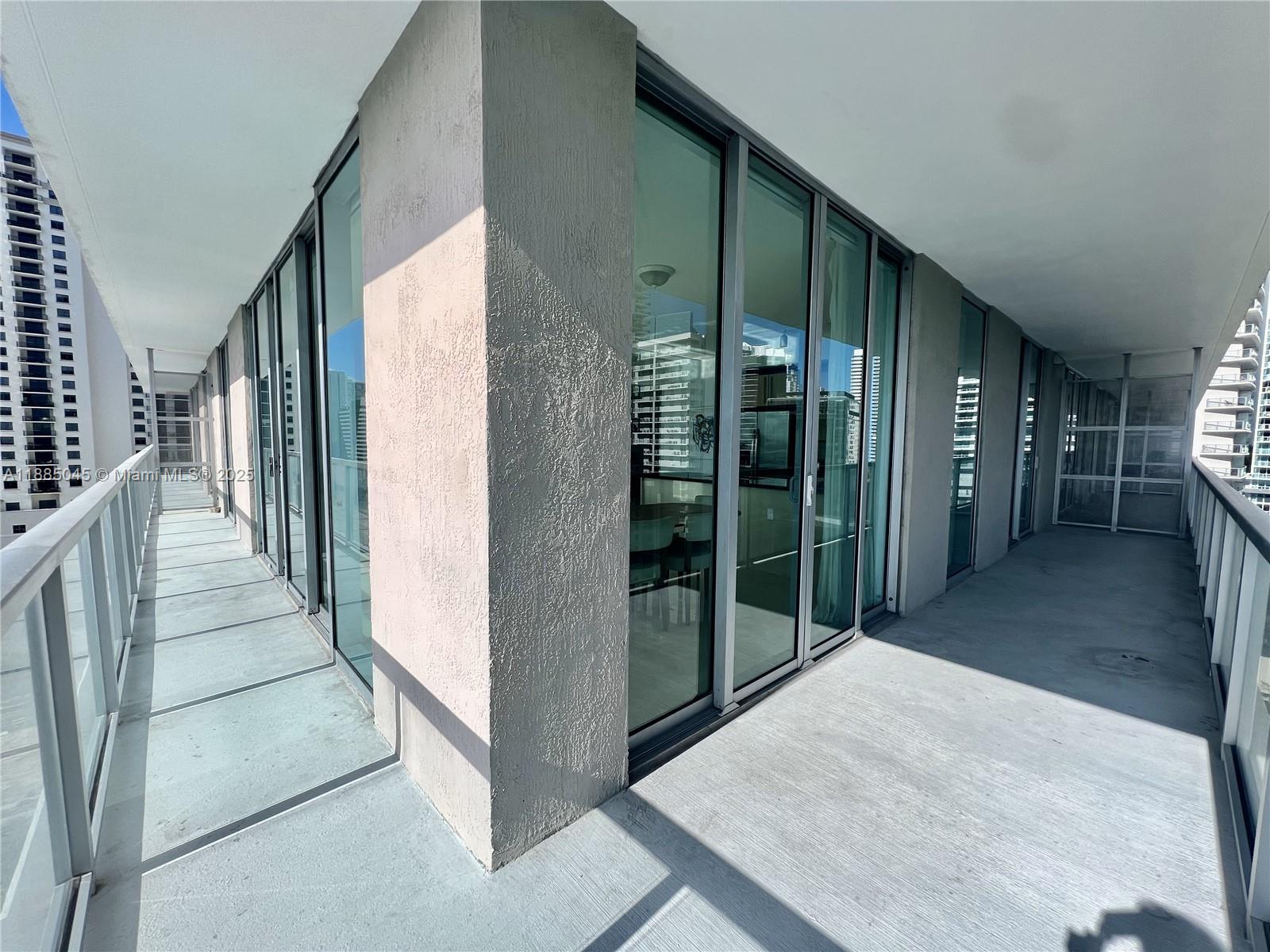 1111 Southwest 1st Avenue, Unit 1914 Miami, FL 33130 - Photo 15 of 31 a view of a hallway with wooden floor and staircase