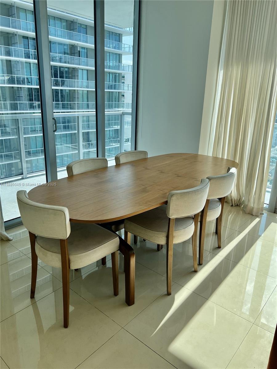 1111 Southwest 1st Avenue, Unit 1914 Miami, FL 33130 - Photo 3 of 31 a view of a dining room with furniture and a window