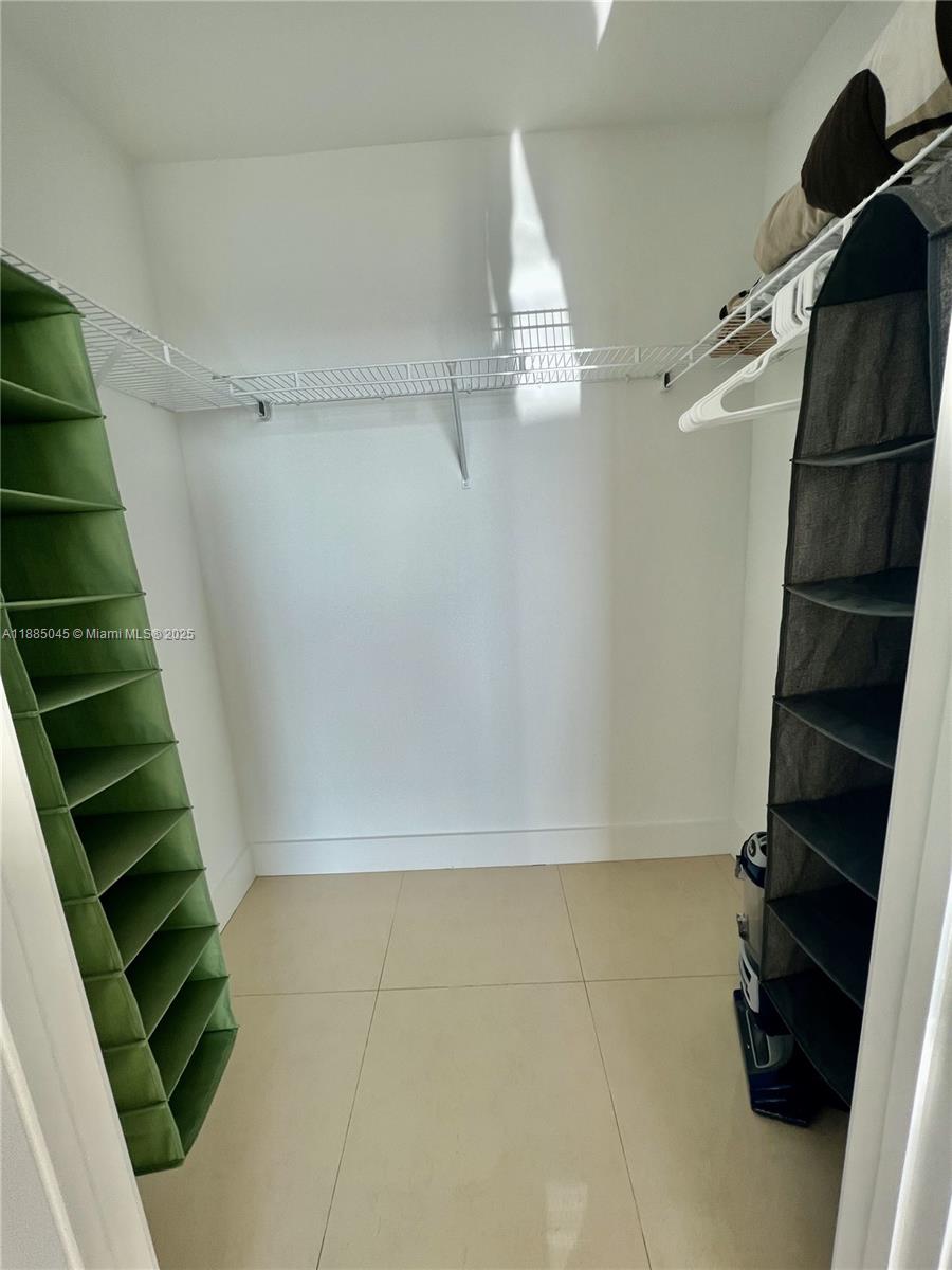 1111 Southwest 1st Avenue, Unit 1914 Miami, FL 33130 - Photo 10 of 31 a view of walk in closet with clothes and shoes