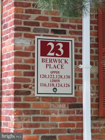 a view of a green yard with a house in the background