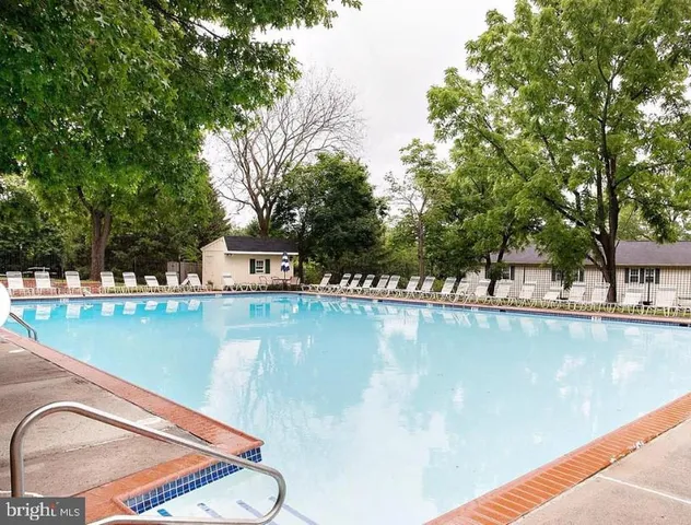a view of a swimming pool with a yard