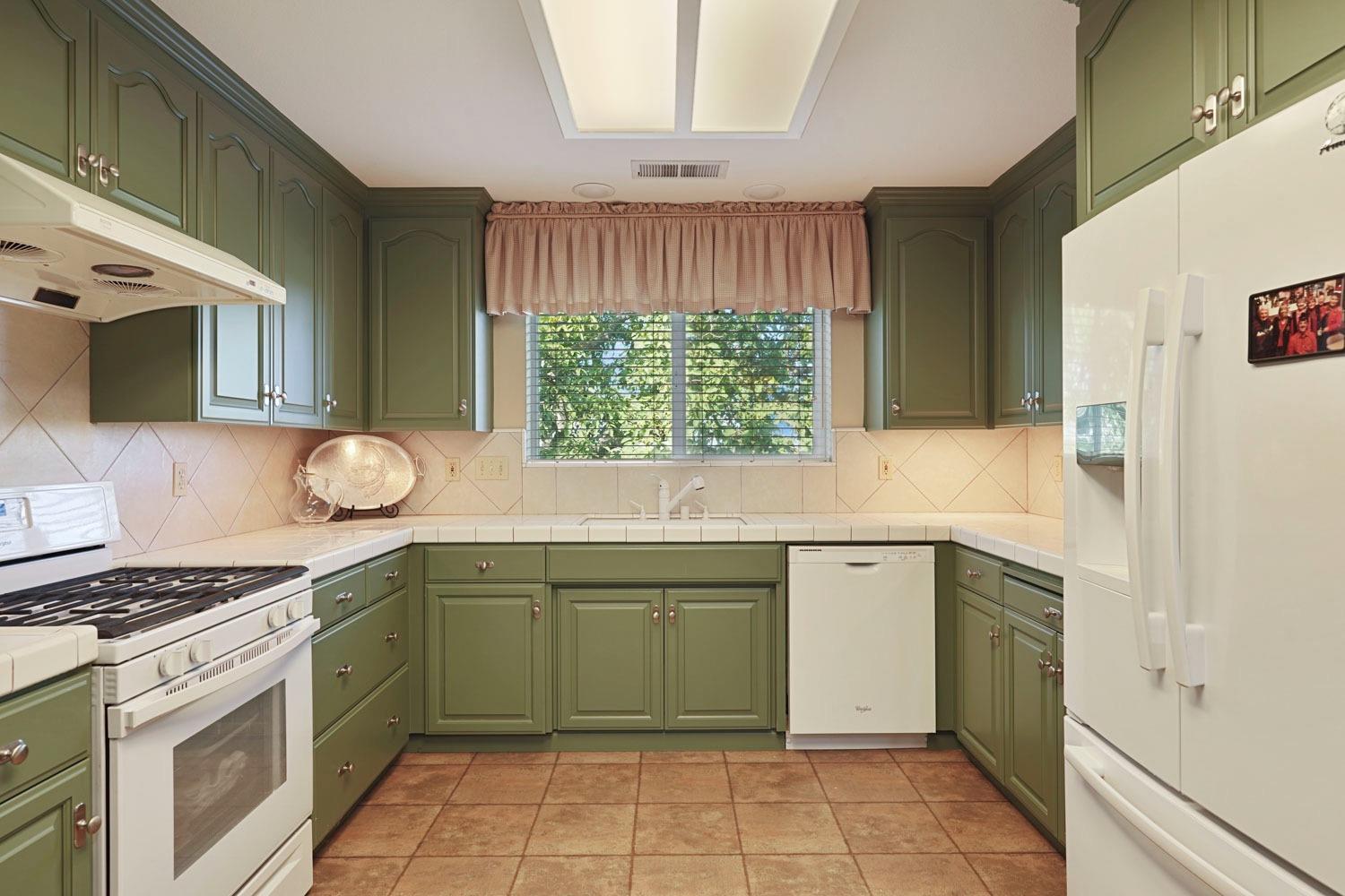 14267 East Peltier Road Acampo, CA 95220 - Photo 18 of 65 a kitchen with a sink stove and cabinets