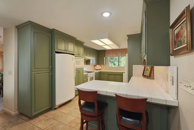 a bedroom with two beds and a chandelier
