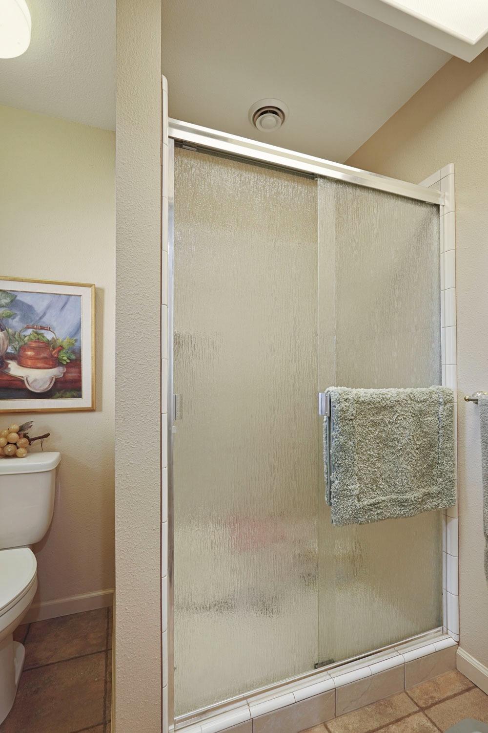 14267 East Peltier Road Acampo, CA 95220 - Photo 24 of 65 a bathroom with a shower and a toilet