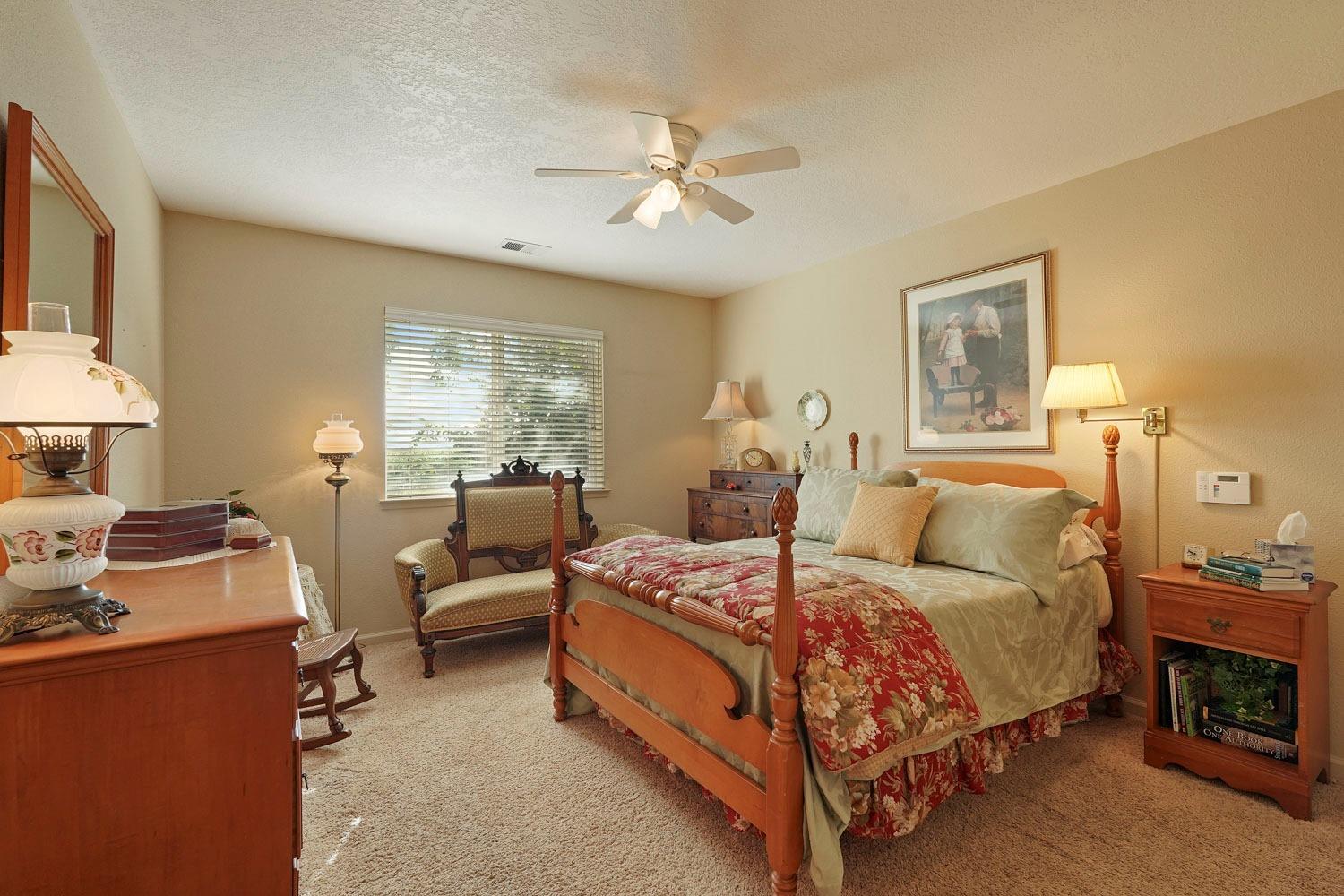 14267 East Peltier Road Acampo, CA 95220 - Photo 27 of 65 a bedroom with a bed and a chandelier