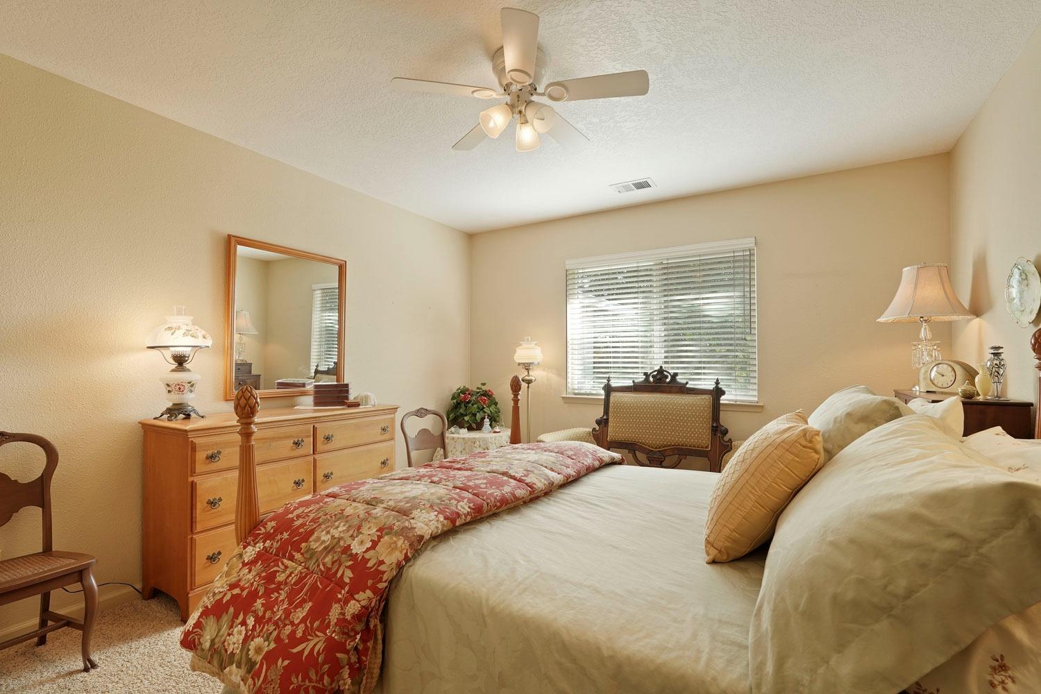 14267 East Peltier Road Acampo, CA 95220 - Photo 28 of 65 a bedroom with two beds and a chandelier