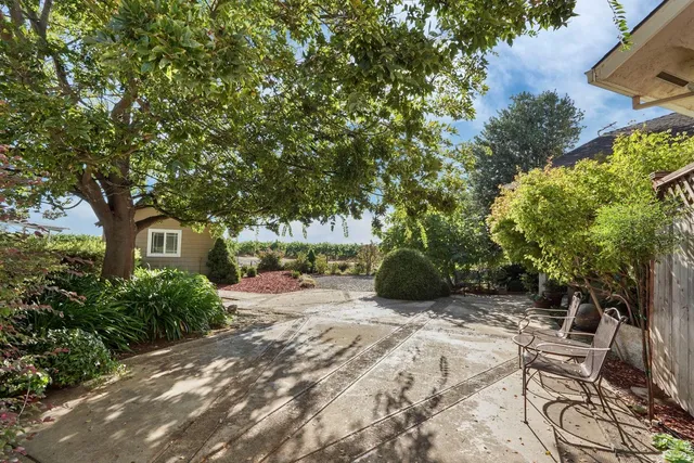 an aerial view of a house with garden space and outdoor seating