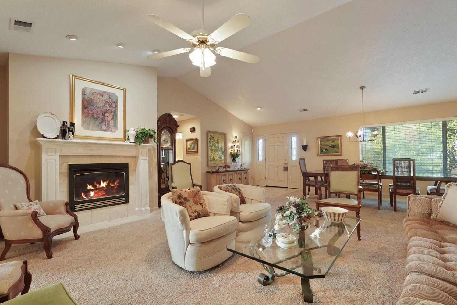 14267 East Peltier Road Acampo, CA 95220 - Photo 10 of 65 a living room with furniture a fireplace and a large window