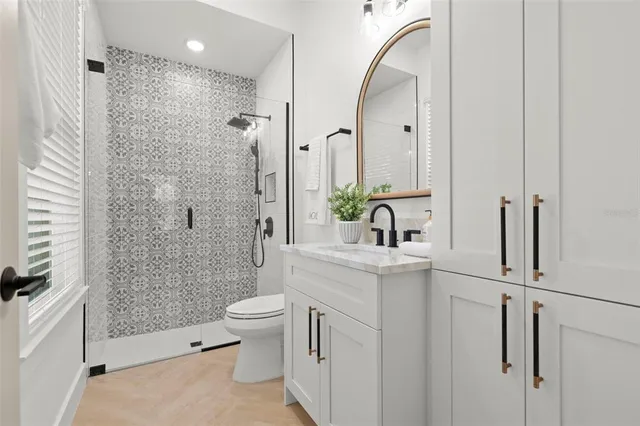 a bathroom with a sink toilet and shower