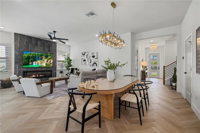 a view of a dining room with furniture and chandelier
