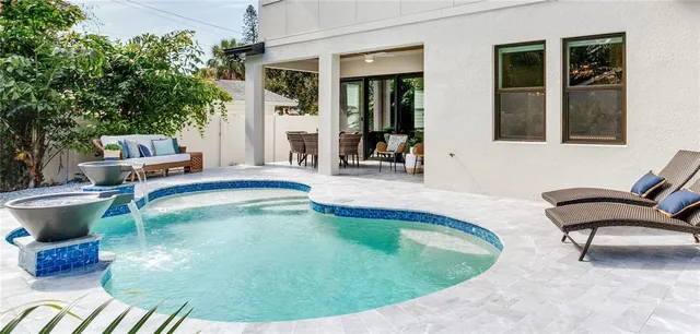 a bathroom with a tub sink and mirror