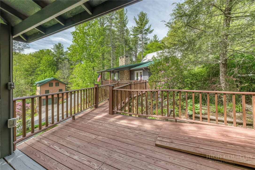 174 Spruce Pine Road Newland, NC 28657 - Photo 3 of 50 a view of deck with wooden floor and fence next to a yard