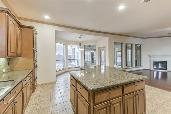 a bathroom with a granite countertop sink a mirror and a bathtub
