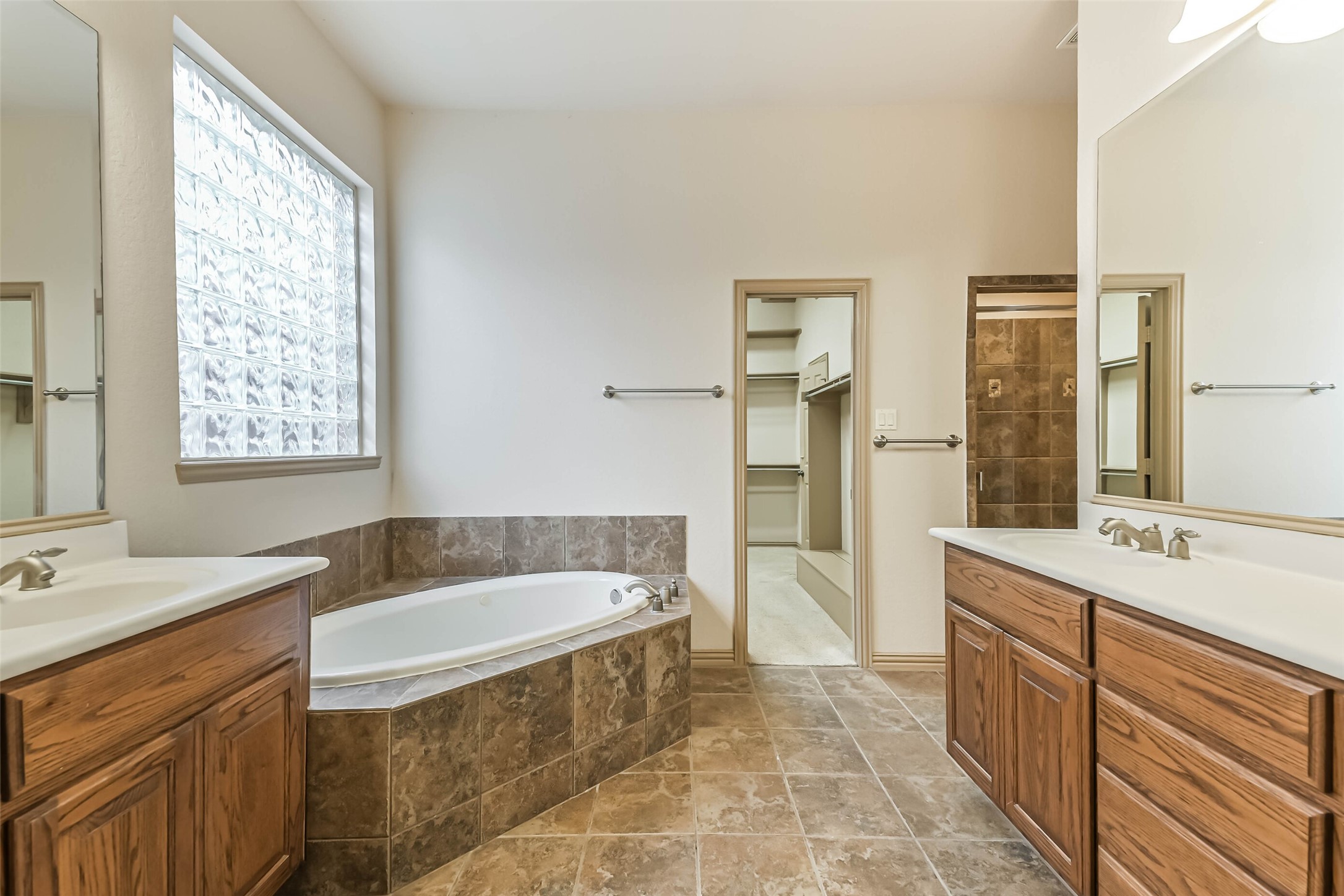 18743 Duke Lake Drive Spring, TX 77388 - Photo 19 of 46 a spacious bathroom with a tub sink and mirror