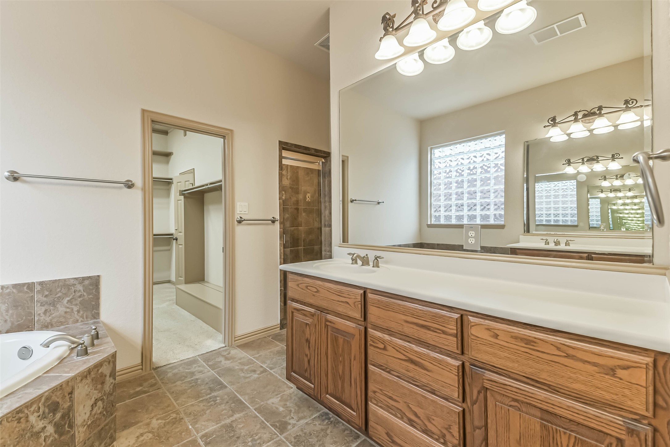 18743 Duke Lake Drive Spring, TX 77388 - Photo 22 of 46 a spacious bathroom with a tub sink and mirror