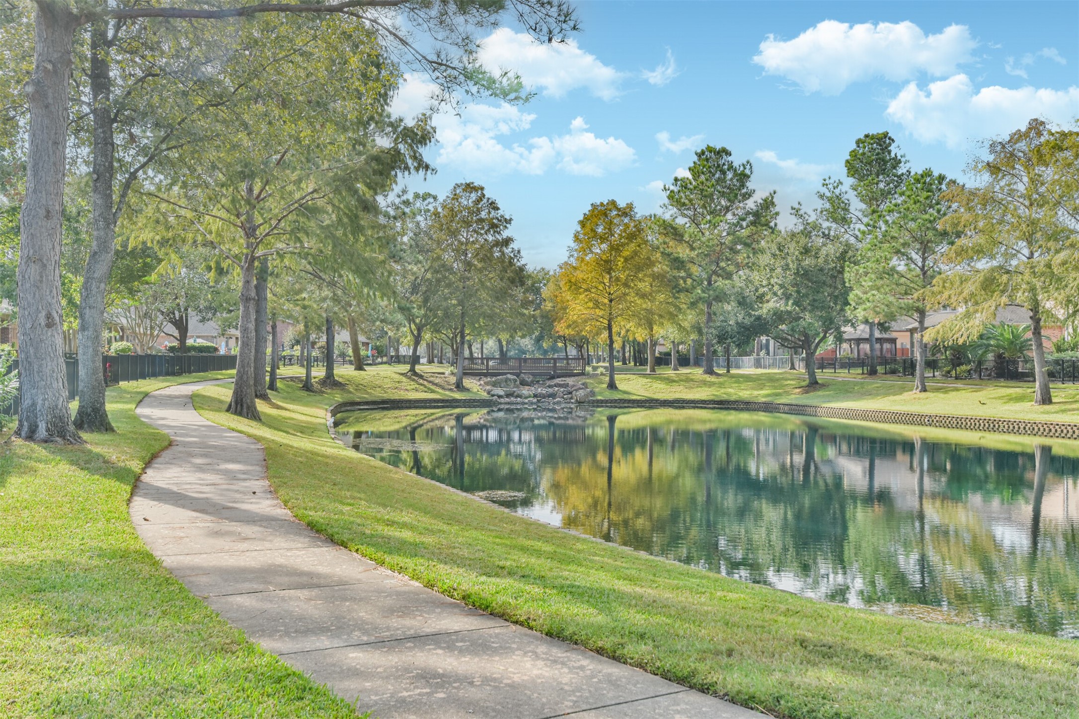 18743 Duke Lake Drive Spring, TX 77388 - Photo 3 of 46 a view of a lake with a yard and large trees