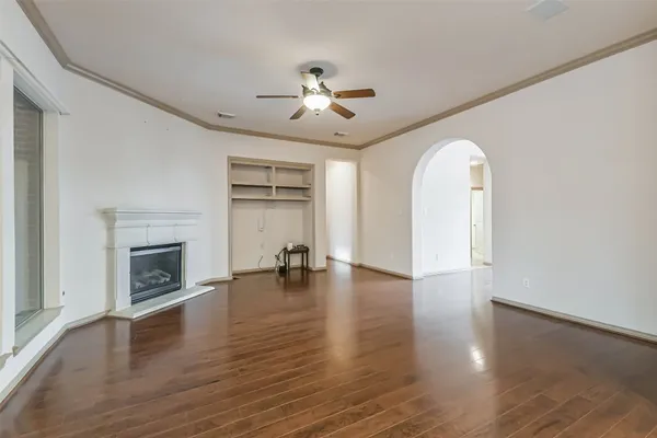 a view of a room with wooden floor and windows