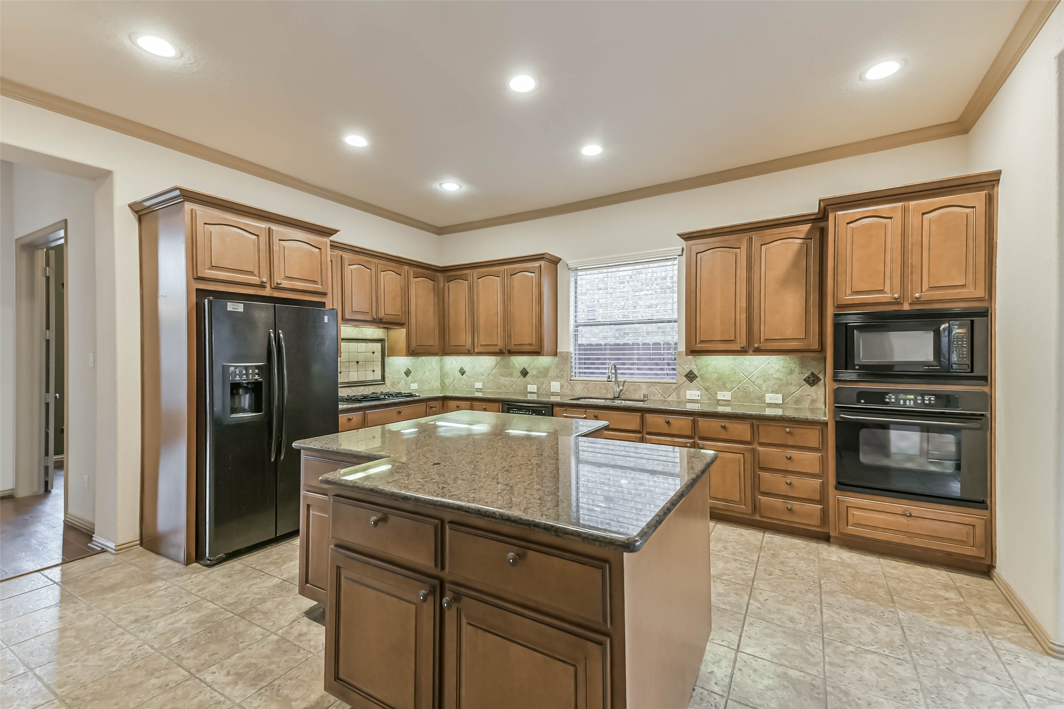 18743 Duke Lake Drive Spring, TX 77388 - Photo 10 of 46 a kitchen with stainless steel appliances granite countertop a refrigerator and a stove top oven
