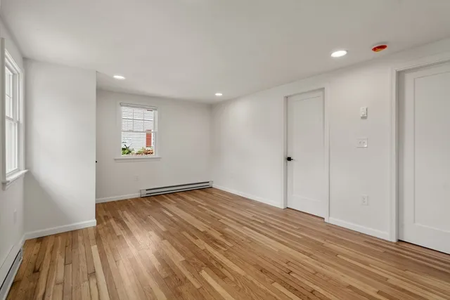wooden floor in an empty room with a window