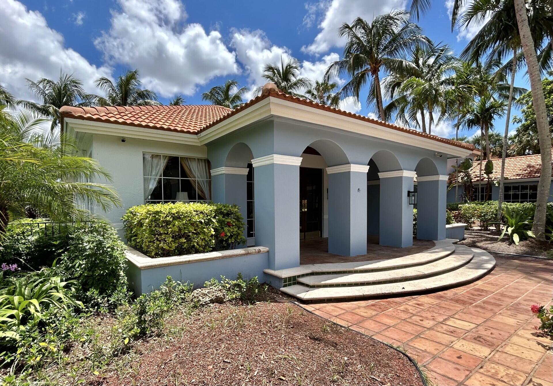 3111 Clint Moore Road, Unit 106 Boca Raton, FL 33496 - Photo 11 of 12 a front view of a house with a garden