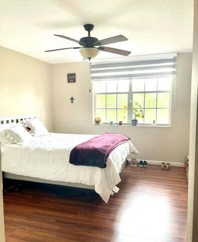 3111 Clint Moore Road, Unit 106 Boca Raton, FL 33496 - Photo 4 of 12 a bedroom with a bed and a window
