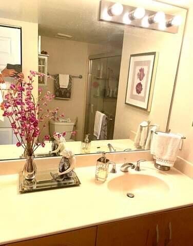 3111 Clint Moore Road, Unit 106 Boca Raton, FL 33496 - Photo 5 of 12 a bathroom with a sink mirror and vanity