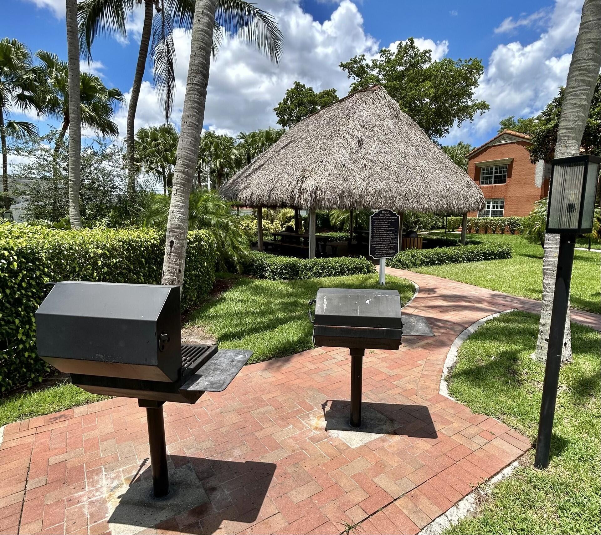 3111 Clint Moore Road, Unit 106 Boca Raton, FL 33496 - Photo 10 of 12 a front view of a house with yard porch and garden