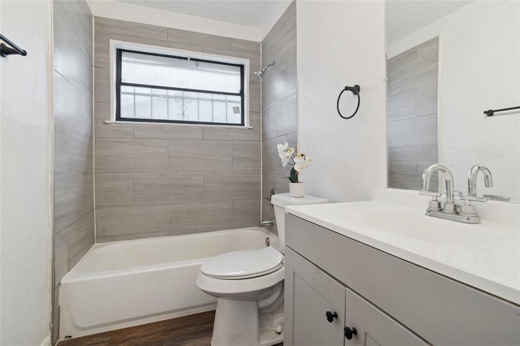 7840 Larchridge Drive Dallas, TX 75232 - Photo 13 of 16 a bathroom with a sink a toilet and shower