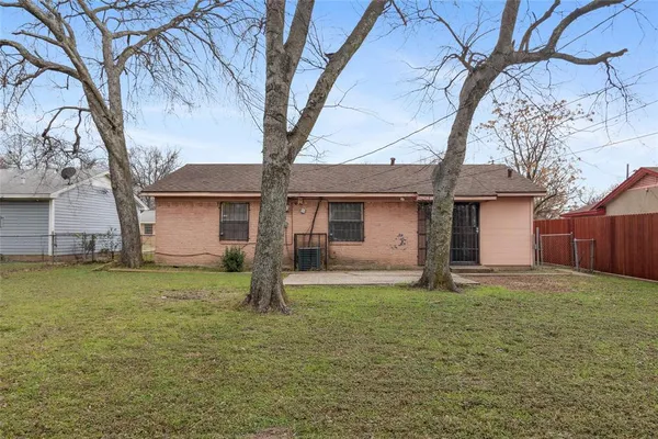 a house that has a tree in front of it