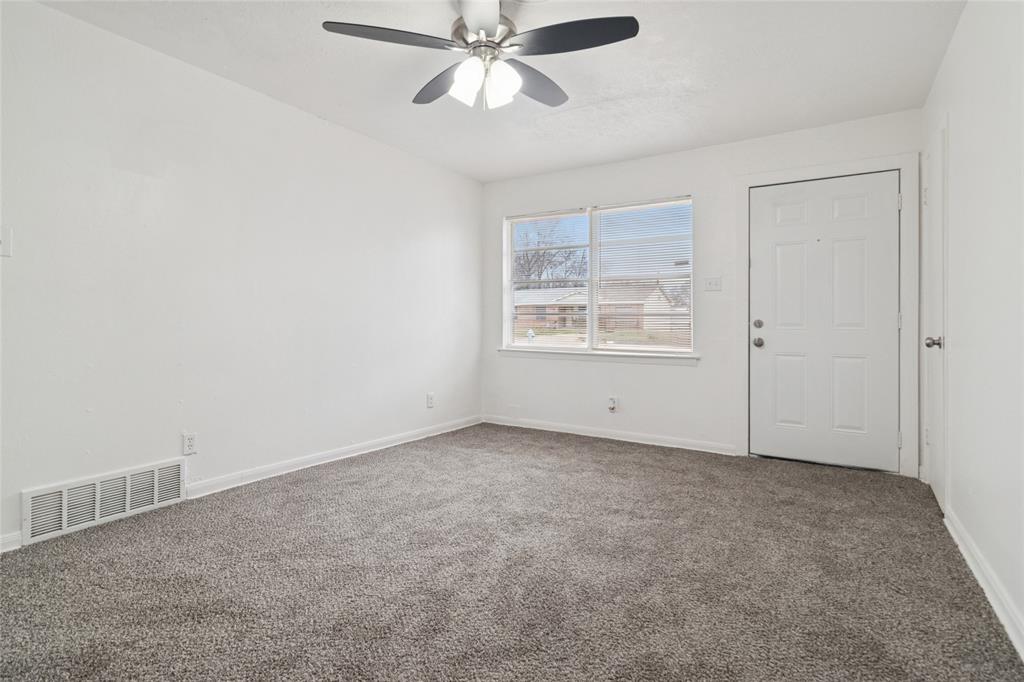 7840 Larchridge Drive Dallas, TX 75232 - Photo 5 of 16 an empty room with windows and fan