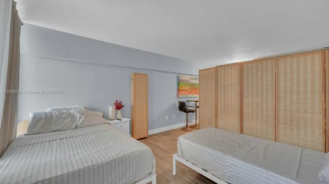 a bedroom with a bed and a dresser in it